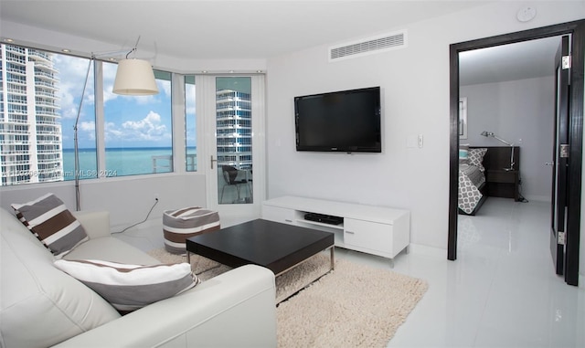 living room with tile flooring and a water view