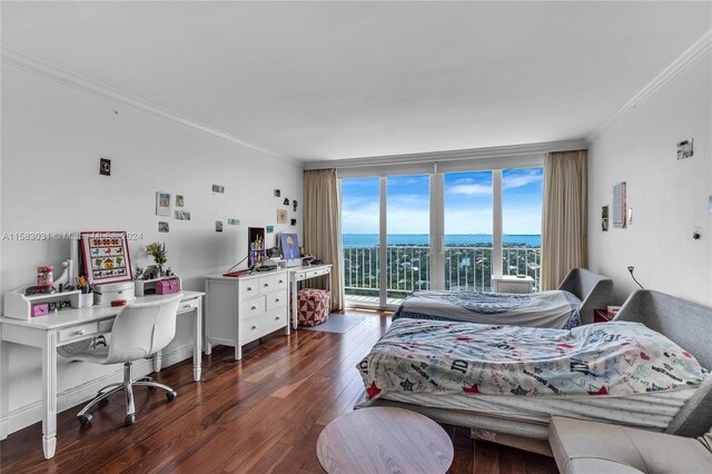 bedroom with access to exterior, dark hardwood / wood-style flooring, a wall of windows, and ornamental molding