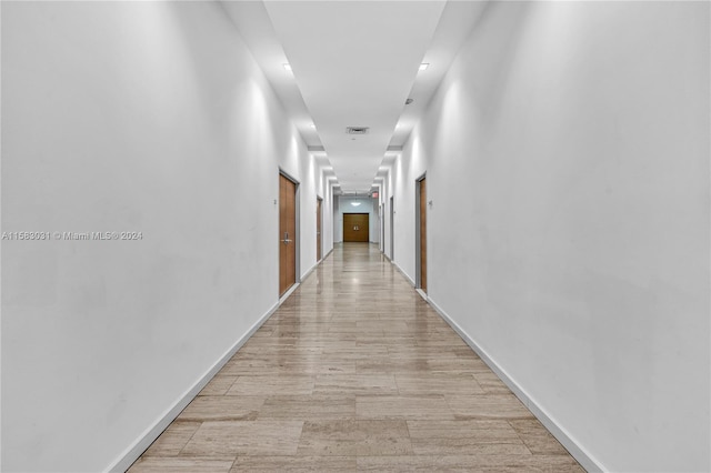 corridor with light wood-type flooring