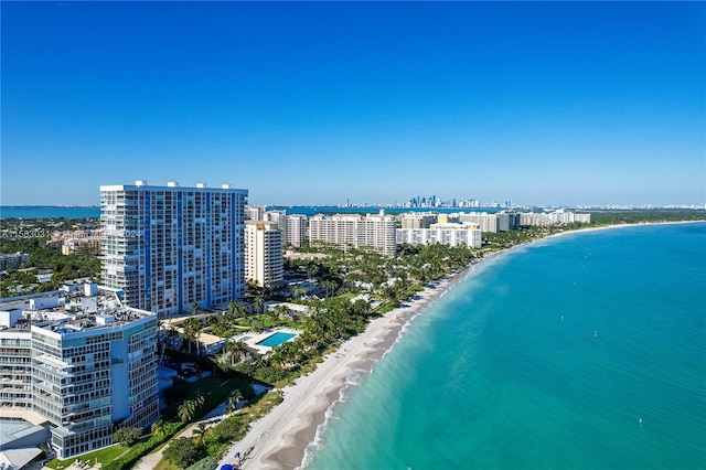 drone / aerial view with a beach view and a water view