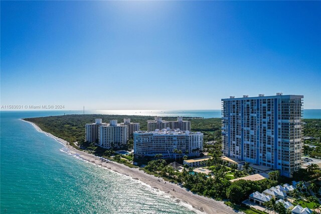 bird's eye view with a water view and a beach view