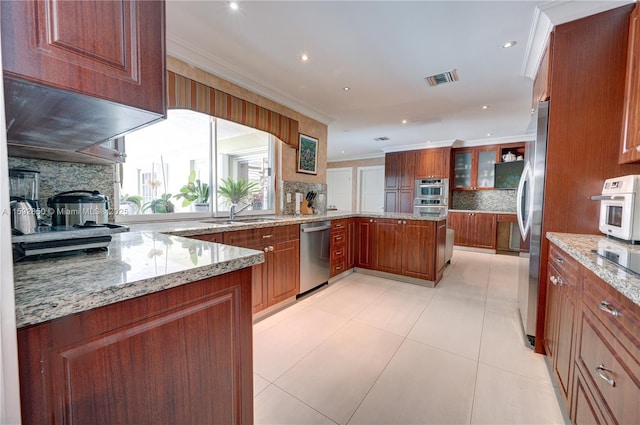 kitchen with stainless steel appliances, light stone counters, ornamental molding, and sink