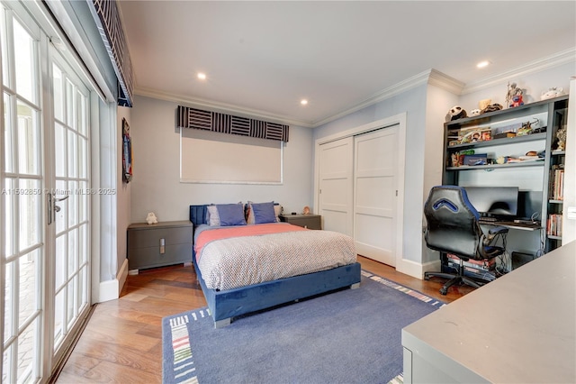 bedroom featuring ornamental molding, a closet, and hardwood / wood-style floors