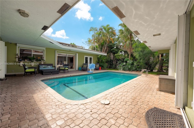 view of pool featuring a patio and outdoor lounge area