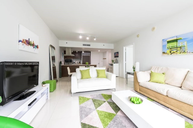 living room with rail lighting and light tile floors