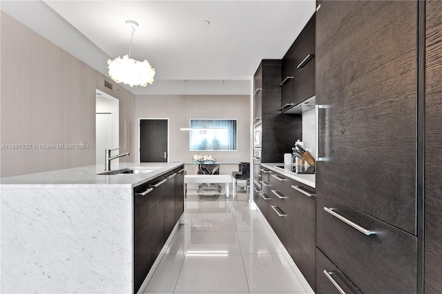 kitchen with black electric cooktop, light tile floors, hanging light fixtures, sink, and a chandelier