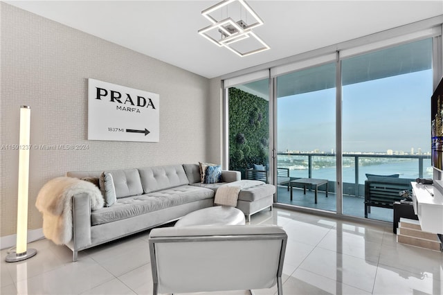 living room featuring a water view, expansive windows, and light tile floors