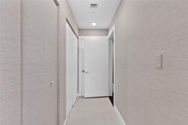 corridor featuring light tile floors