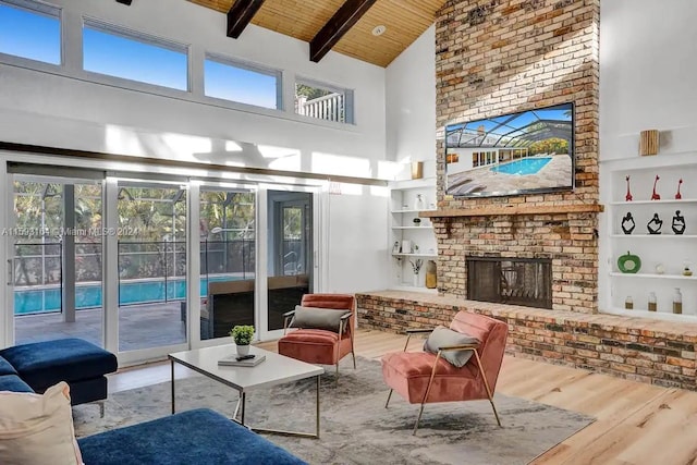 living room with high vaulted ceiling, plenty of natural light, a fireplace, and wood ceiling