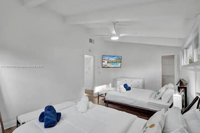 bedroom featuring wood-type flooring, lofted ceiling with beams, and ceiling fan