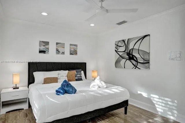 bedroom with ceiling fan and hardwood / wood-style floors