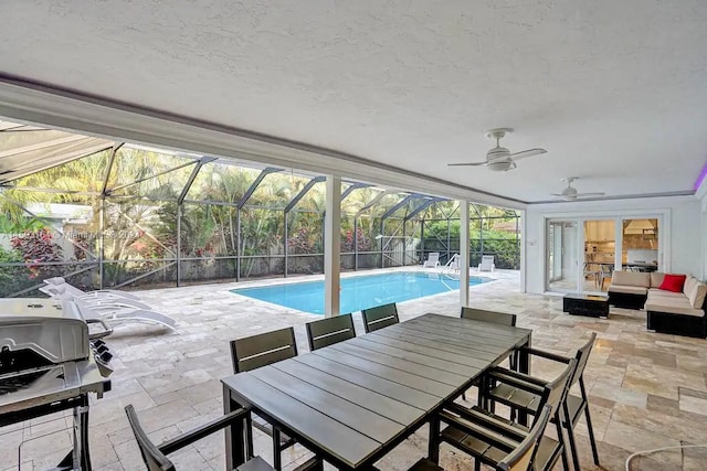 view of pool featuring a patio, a lanai, an outdoor living space, and ceiling fan