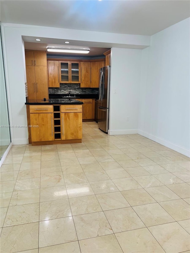 kitchen featuring stainless steel refrigerator, wine cooler, sink, backsplash, and light tile patterned flooring