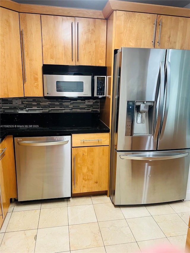 kitchen featuring decorative backsplash, light tile patterned flooring, and stainless steel appliances