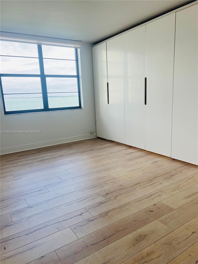 unfurnished bedroom with light hardwood / wood-style floors