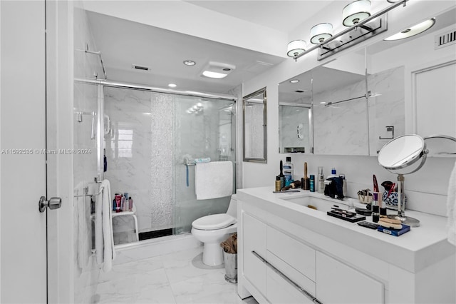 bathroom featuring tile patterned floors, a shower with door, vanity, and toilet