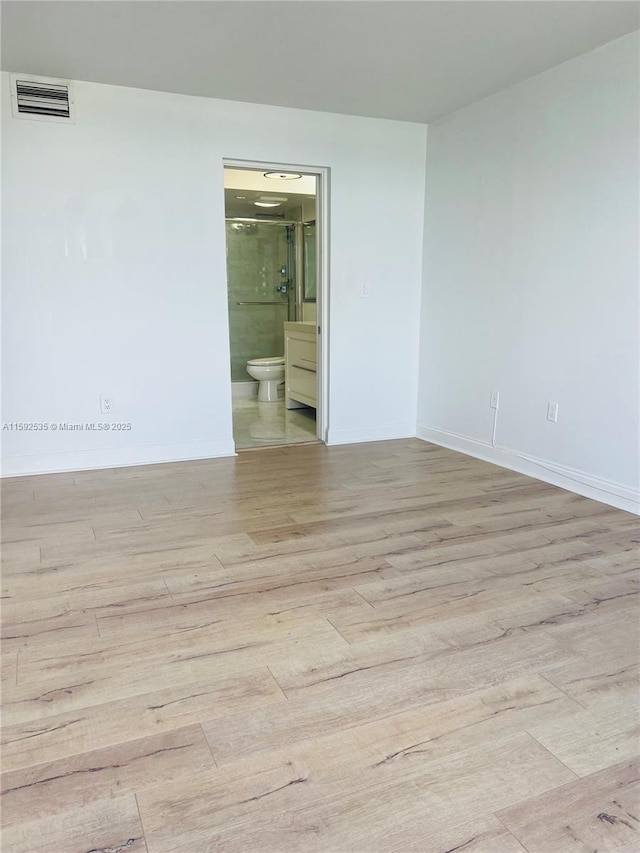 unfurnished room featuring light wood-type flooring