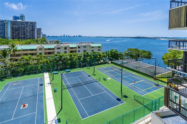 view of tennis court with a water view