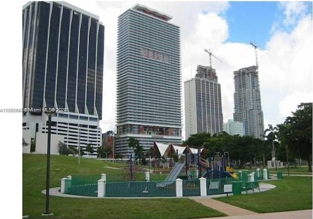 surrounding community featuring a playground and a yard