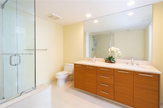 bathroom featuring walk in shower, toilet, double sink vanity, and tile floors