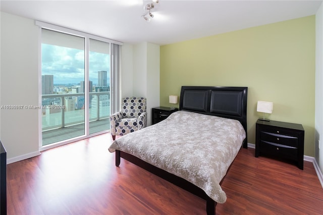 bedroom featuring access to outside and dark hardwood / wood-style flooring