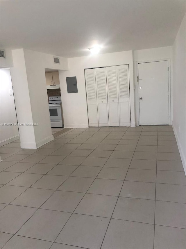 unfurnished bedroom featuring a closet and light tile floors