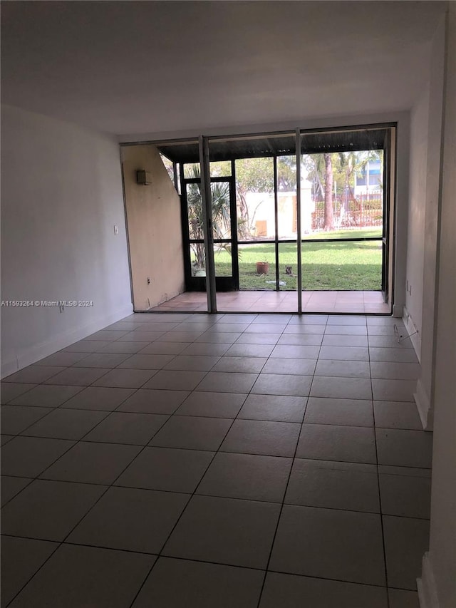 empty room featuring dark tile flooring