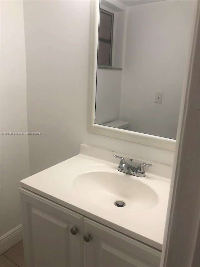 bathroom featuring tile flooring and vanity