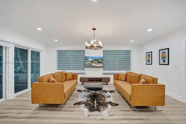 living room featuring a chandelier and light hardwood / wood-style flooring