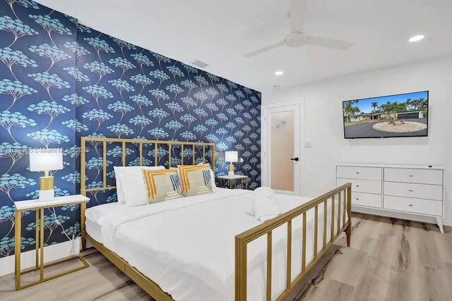 bedroom with ceiling fan and light hardwood / wood-style flooring