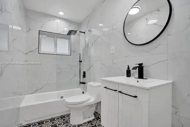 full bathroom with vanity, toilet, tiled shower / bath combo, and tile walls