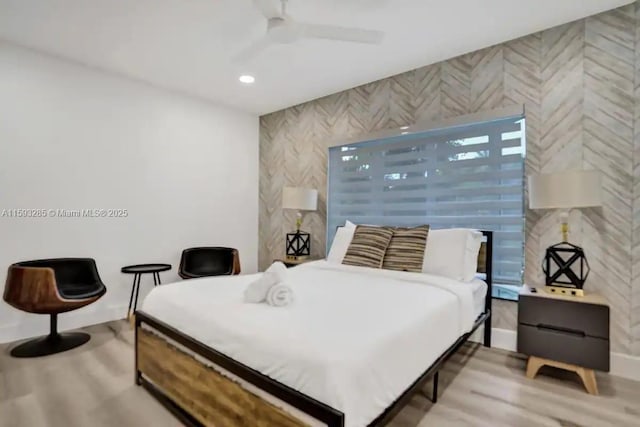 bedroom with ceiling fan and light wood-type flooring