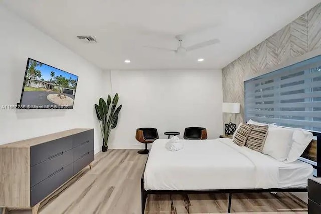 bedroom with ceiling fan and light wood-type flooring