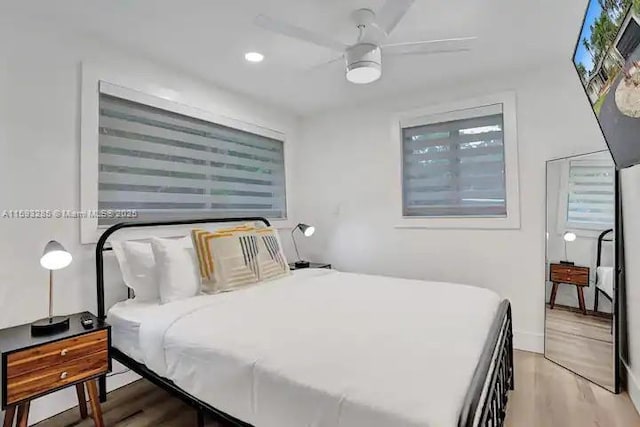 bedroom with ceiling fan and light wood-type flooring