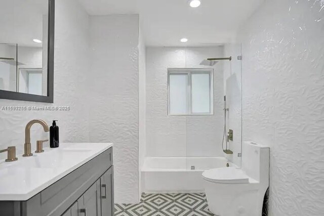 full bathroom featuring toilet, vanity, and shower / washtub combination