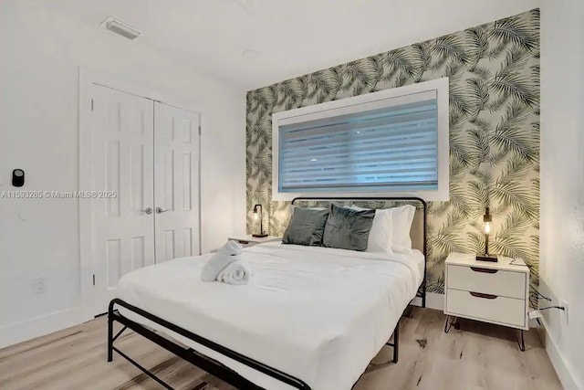 bedroom featuring light hardwood / wood-style flooring and a closet