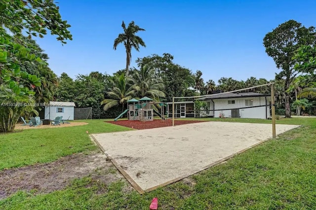 view of home's community with a storage shed, a yard, volleyball court, and a playground