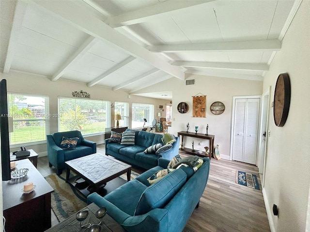 living room with vaulted ceiling with beams, plenty of natural light, and wood-type flooring