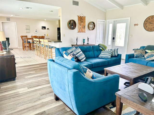 living room featuring lofted ceiling with beams and wood-type flooring