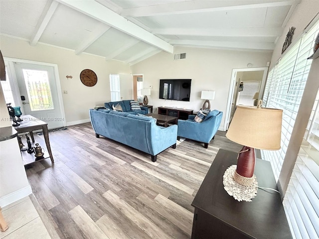 living room featuring lofted ceiling with beams and hardwood / wood-style flooring