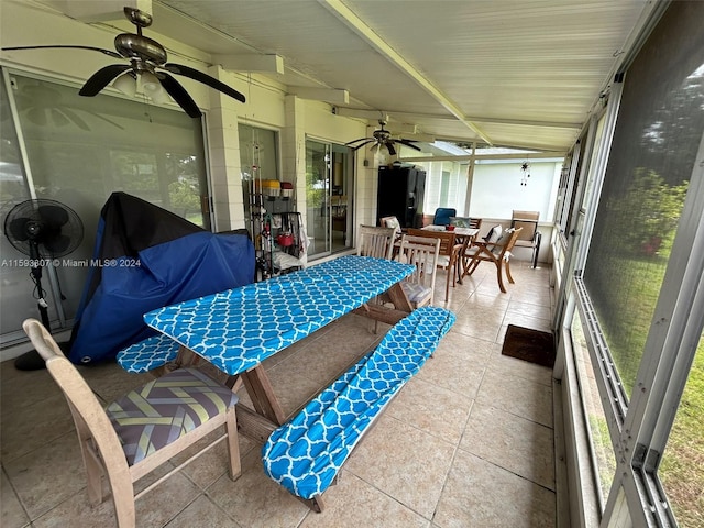 sunroom featuring a healthy amount of sunlight and ceiling fan