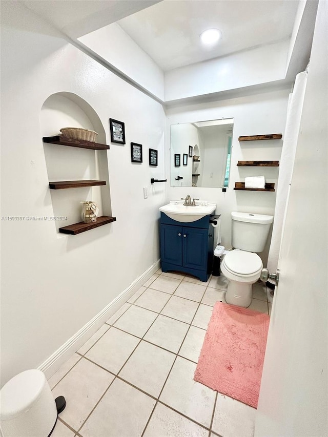 bathroom with vanity, toilet, and tile floors