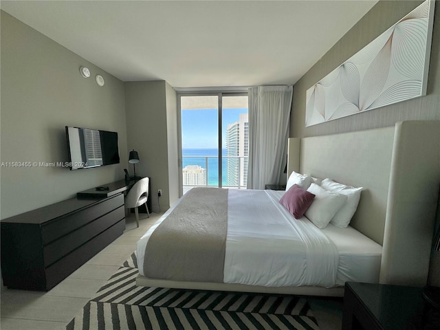 bedroom featuring access to outside, light hardwood / wood-style floors, and floor to ceiling windows