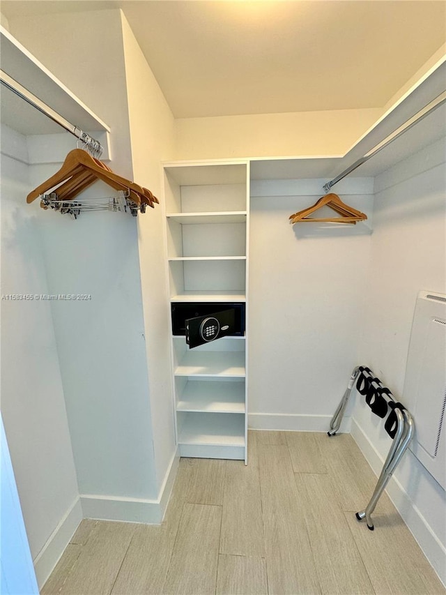 walk in closet featuring light hardwood / wood-style flooring