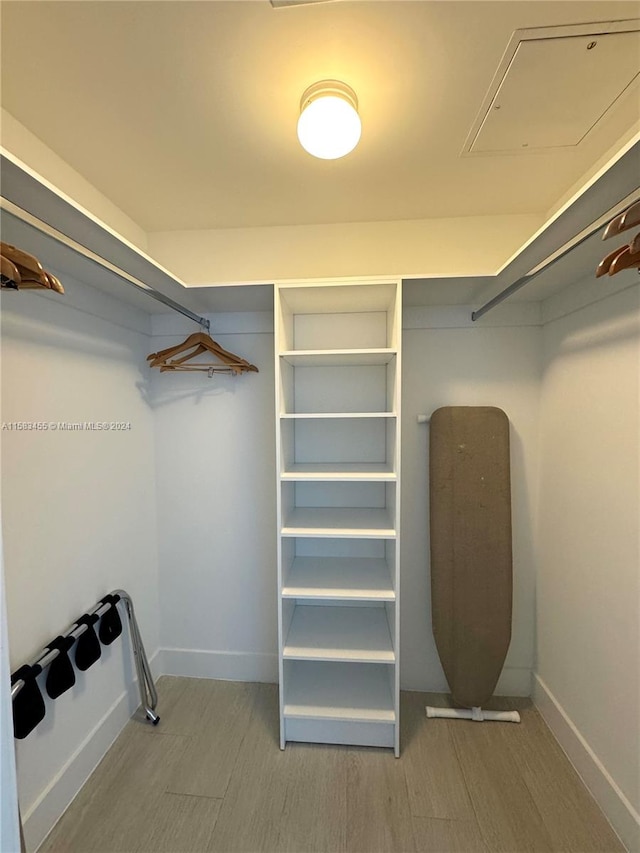 spacious closet featuring hardwood / wood-style flooring