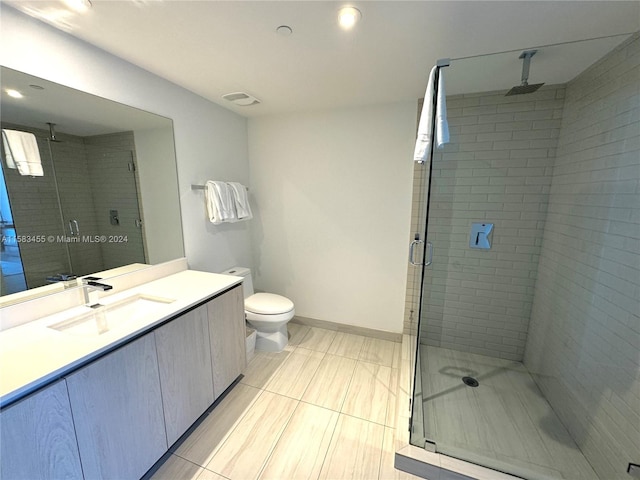 bathroom with tile patterned floors, vanity, walk in shower, and toilet