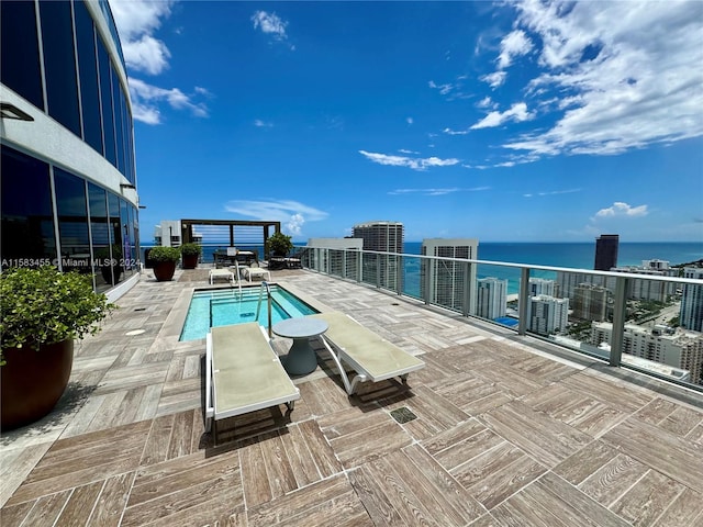 view of swimming pool featuring central AC unit and a water view