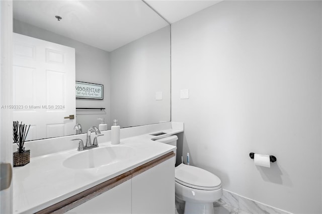 bathroom featuring tile flooring, toilet, and vanity