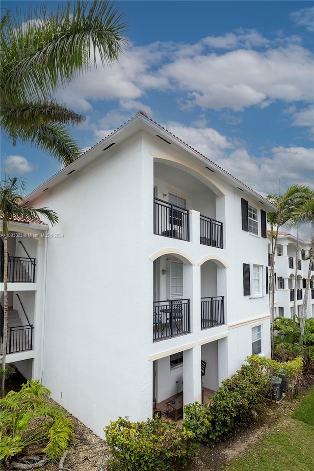 view of home's exterior with a balcony and central air condition unit