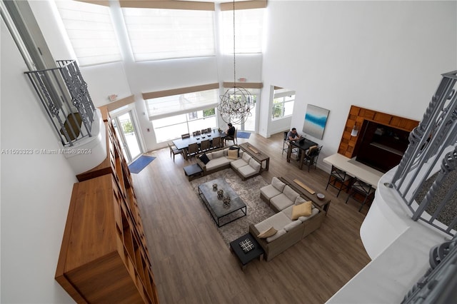 living room with a high ceiling and hardwood / wood-style floors